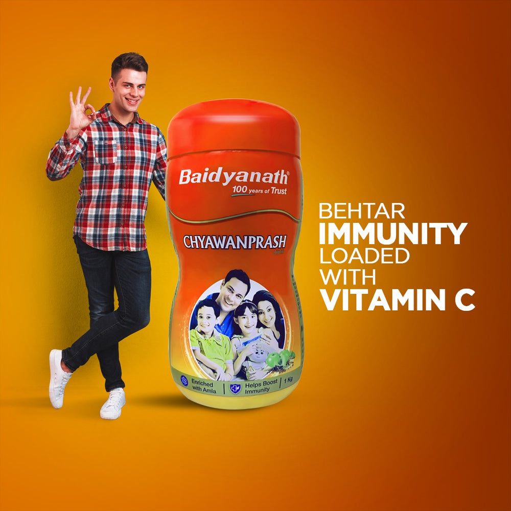 A man showcasing the Baidyanath Chyawanprash Avleha box, packed with vitamin C for better immunity.